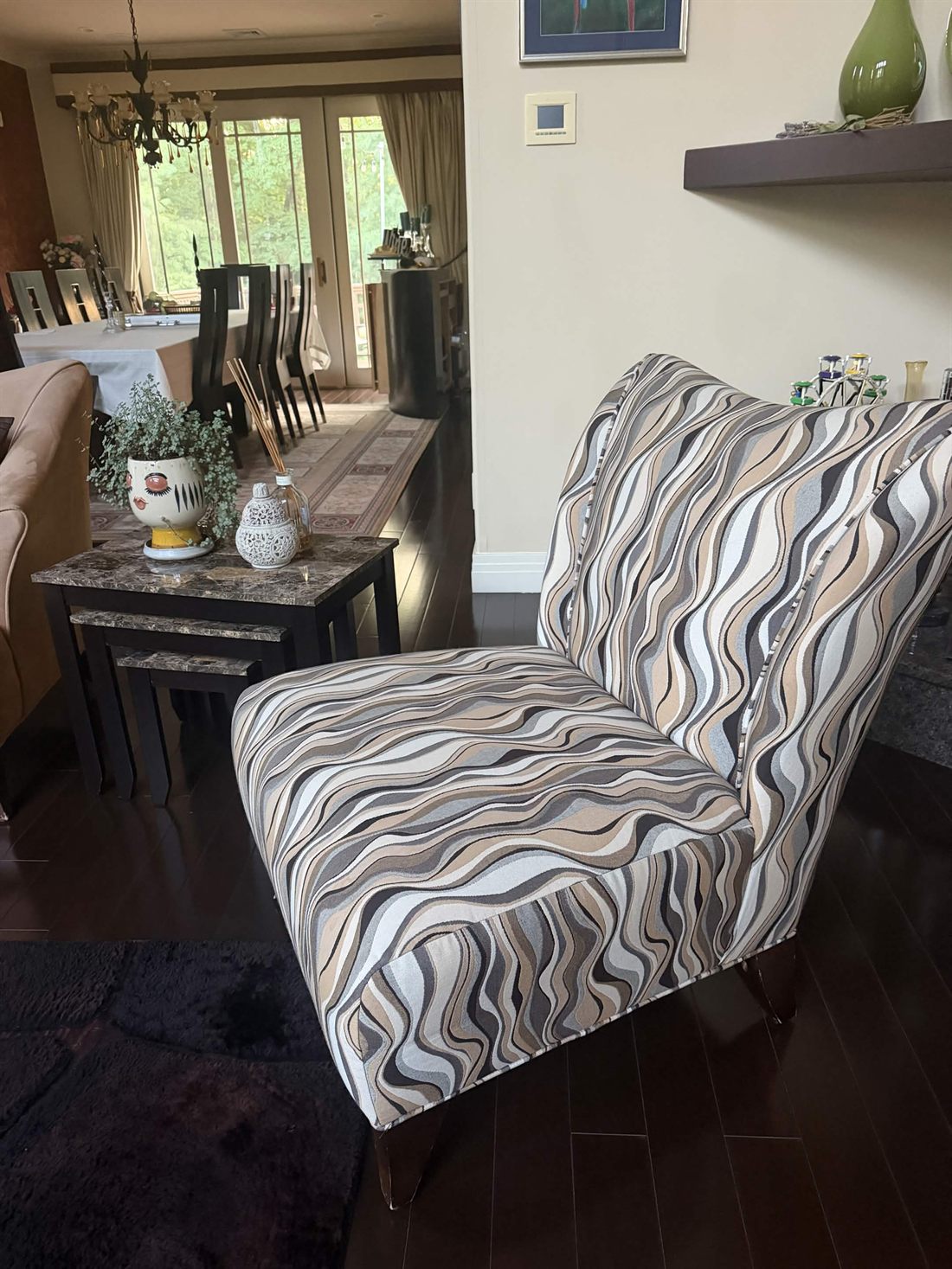 An accent chair photographed quickly in a living room, exactly as a phone would capture it